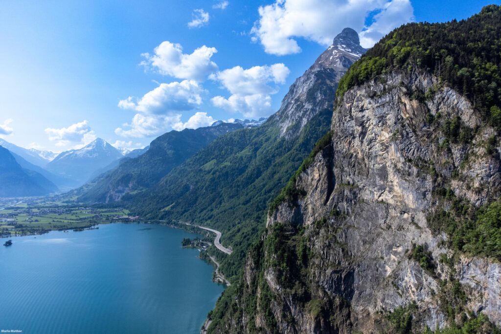 Eine faszinierende Drohnenfotografie erfasst den Blick Richtung Gitschen und Bristen im Kanton Uri. Das Bild präsentiert eine atemberaubende Vogelperspektive, die die Berge und die umliegende Landschaft in ihrer vollen Pracht zeigt.